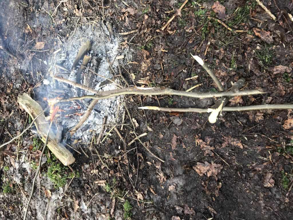 Makeshift barbecue set-up on forest school fire